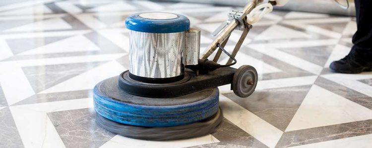 man polishing marble floor in modern office building